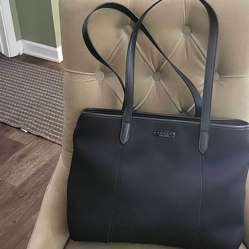 This is a black nylon Coach tote shaped bag.